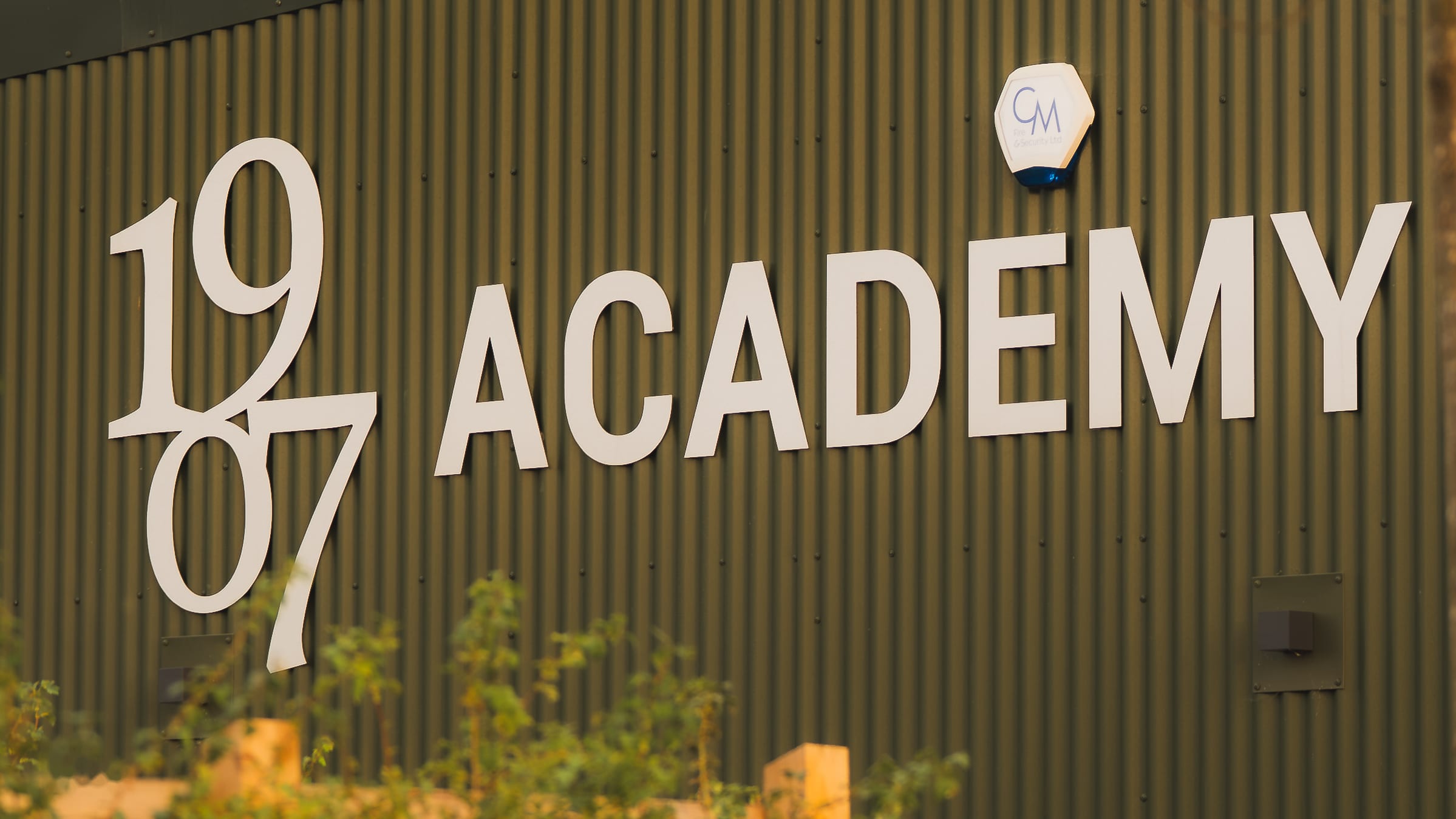 The "1907 Academy" signage on the building's cladding