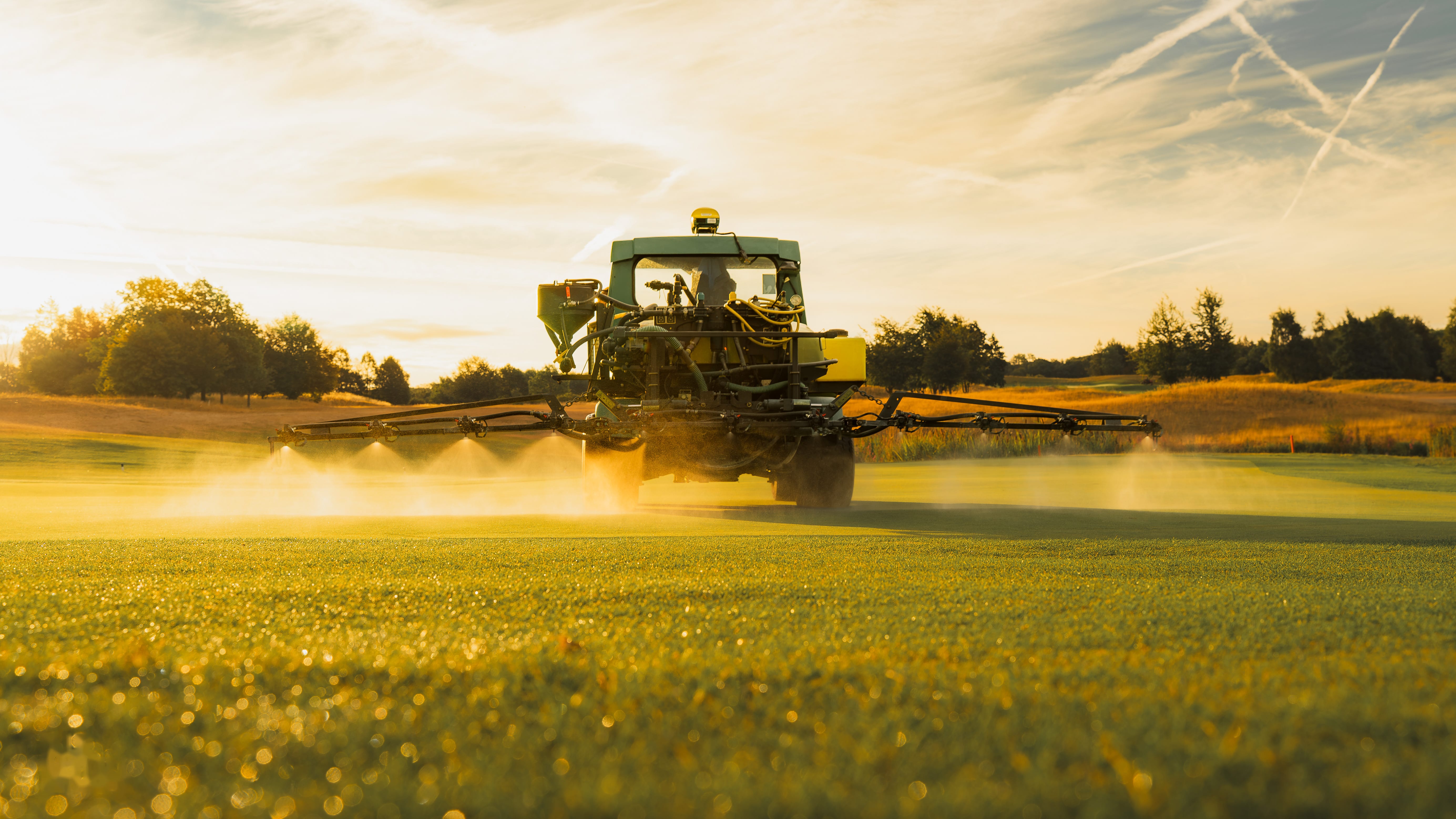 Irrigation catching the evening light as it sprays across a green
