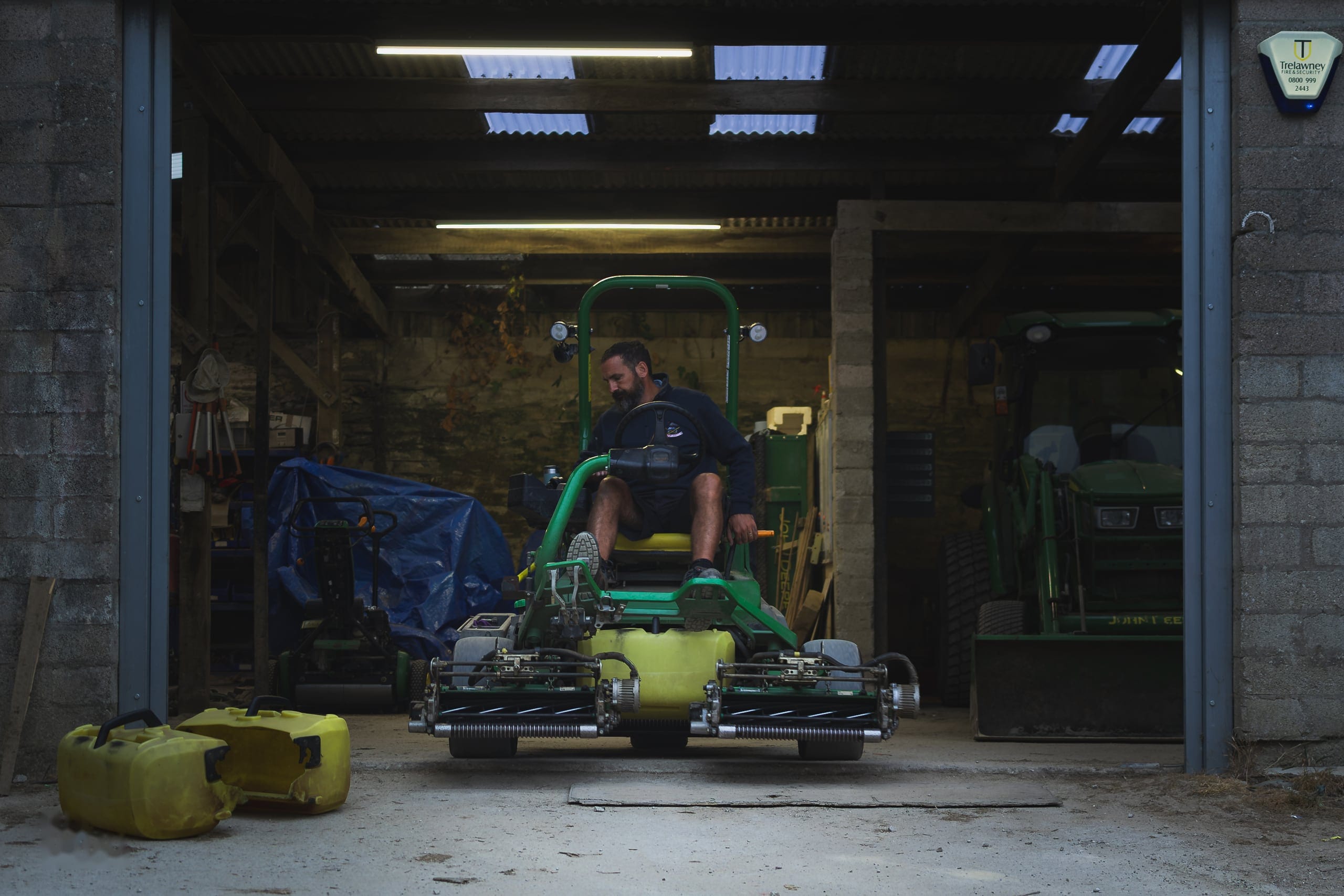 Machinery lined up inside the greenkeeping shed