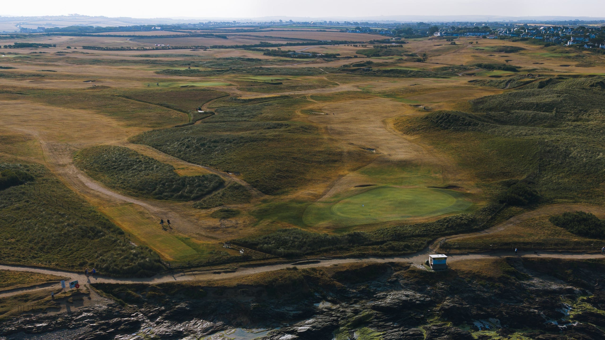 Aerial view across a links course towards the sea