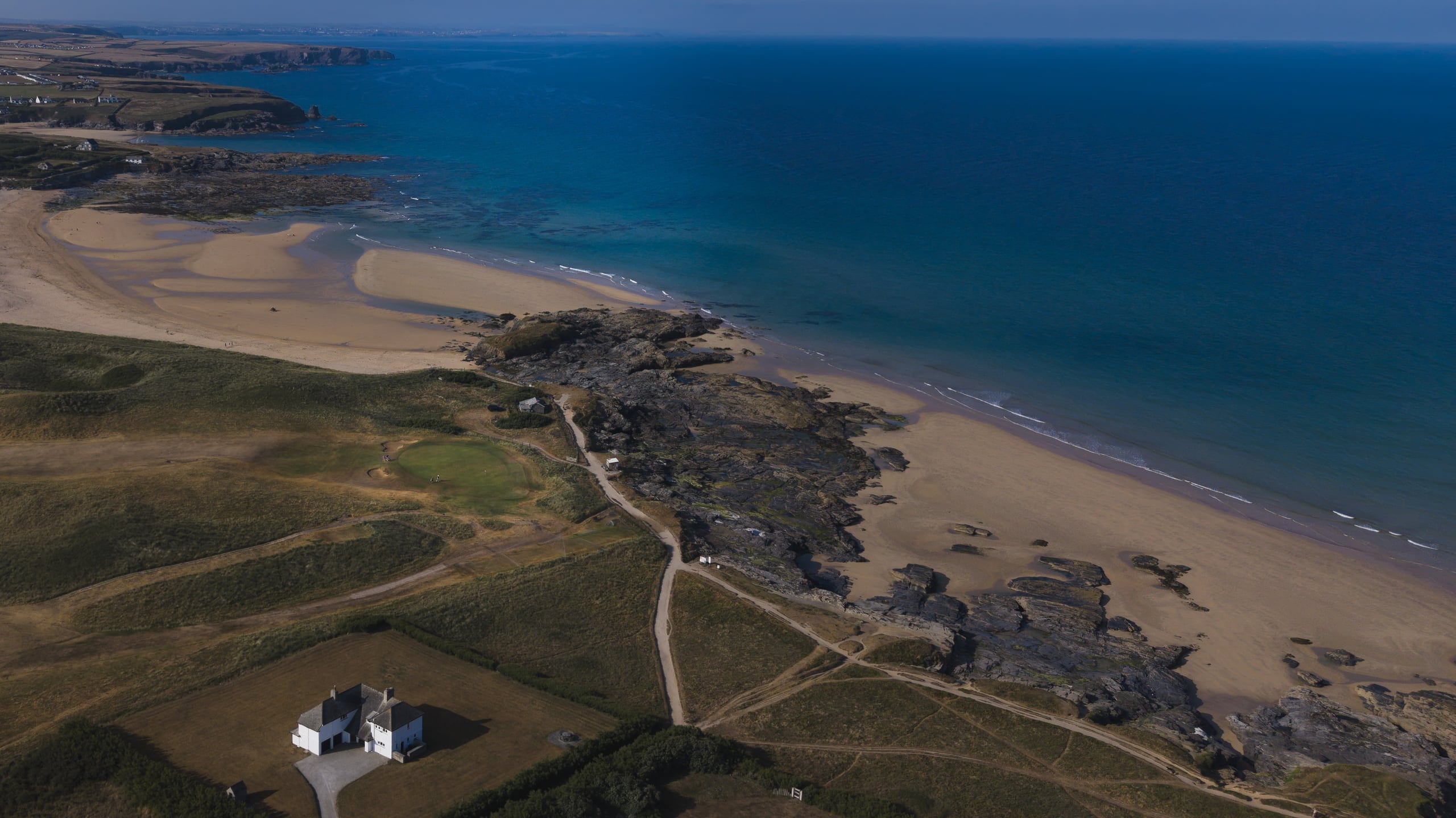 Aerial view of the Trevose links running along the coastline