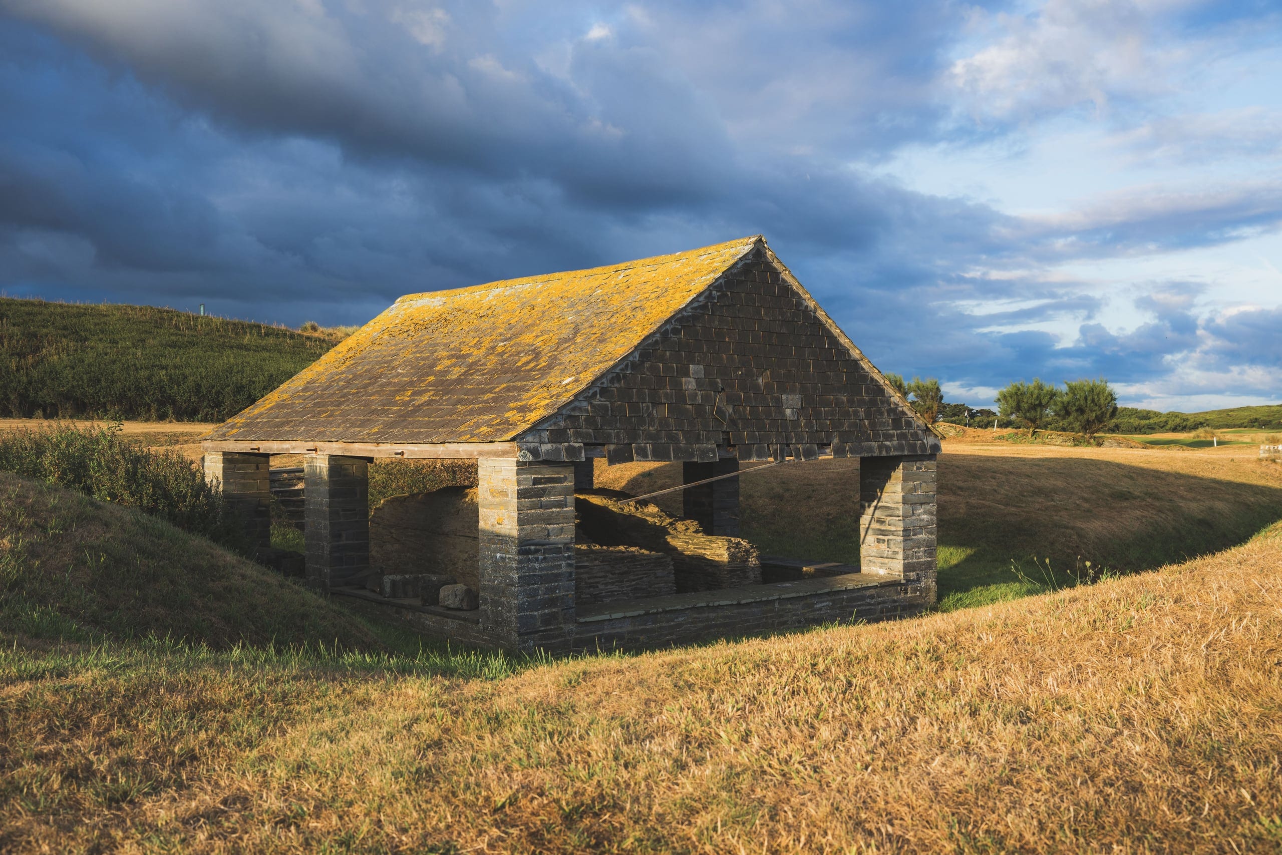 A stone barn standing in the dunes above the course